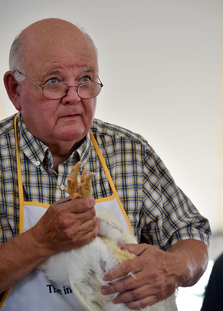 Judge Tony Perryman feels the body of a chicken
